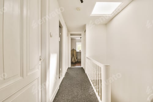 Preview: a hallway with white walls and a carpeted floor