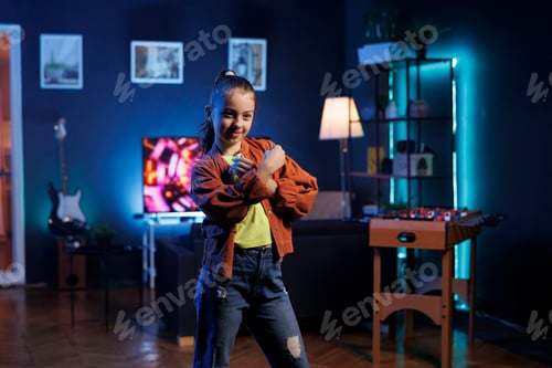Preview: Cute kid dancing inside neon lit home studio, creating content for online fans