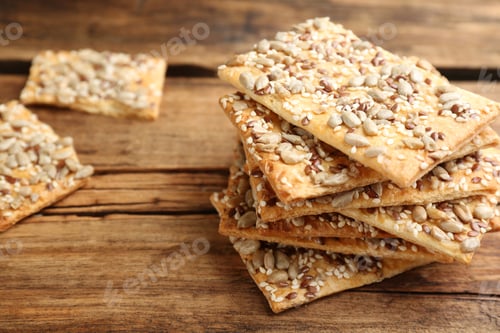 Preview: Stack of delicious crackers on wooden table, closeup