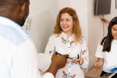 Preview: Happy ginger female teacher smiling to her colleagues.