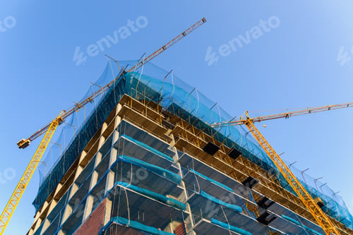 Preview: Yellow crane in a construction site to lift large weights of construction material