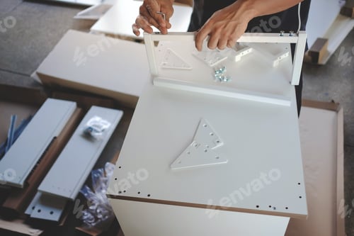 Preview: Assembling Furniture at Home. Moving for a New House or DIY Concept. Man Installing the Cabinet