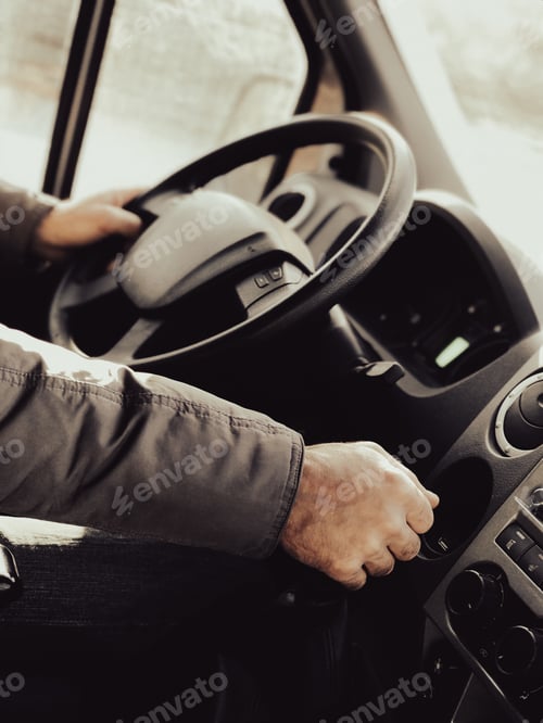 Preview: A man is driving a truck. Close-up. A man's hand switches the gear lever