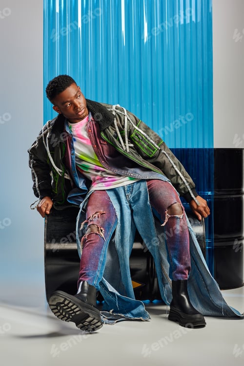 Preview: Confident young afroamerican male model in ripped jeans and outwear jacket with led stripes