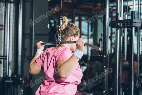 Preview: overweight woman working out on training apparatus