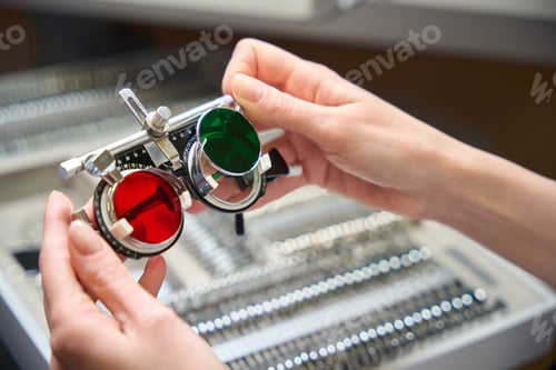 Preview: Special glasses with multi-colored trial lenses in the doctors hands