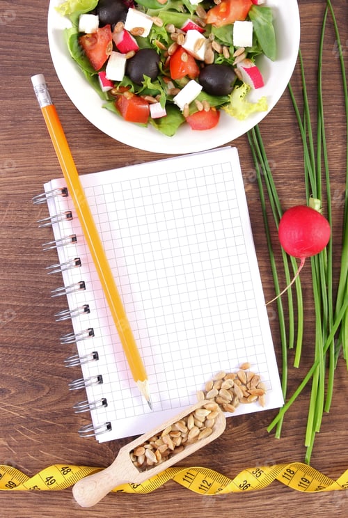 Preview: Fresh greek salad with vegetables, centimeter and notepad for writing notes