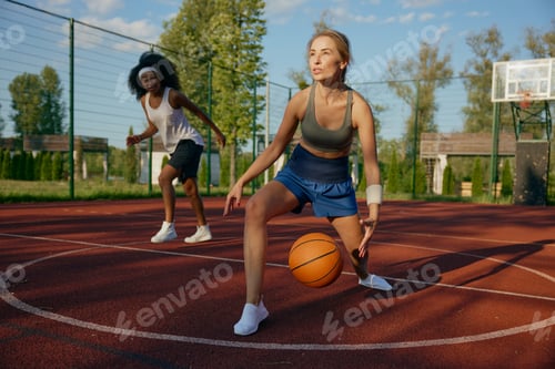 Preview: Female basketball players running with ball ready to pass into basket