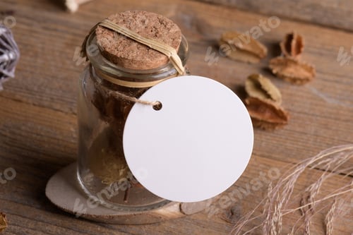 Preview: Round white tag mockup on glass jar with dry perfume a wooden background with boho decoration