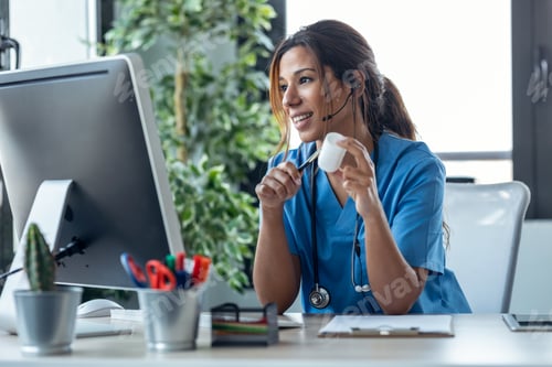 Preview: Female doctor with earphone while explaining medical treatment to patient through a video call