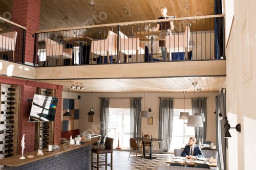 Preview: Modern comfortable restaurant with customer and waitress
