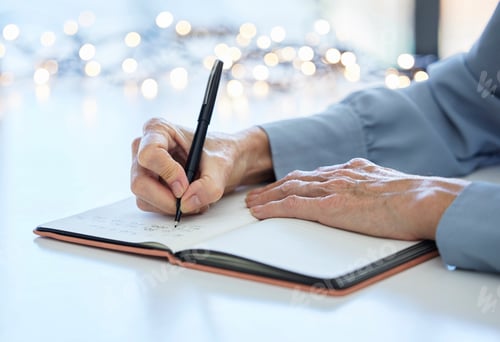 Preview: Notebook, pen and hands of old woman writing calendar schedule, checklist or business ideas in plan