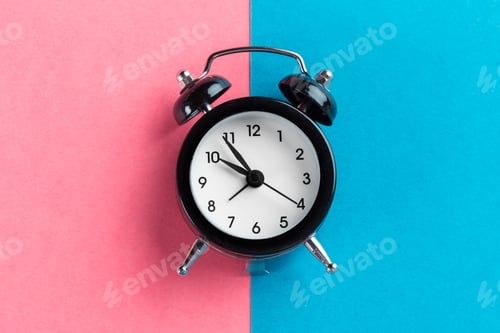 Preview: Vintage black alarm clock on a color block background