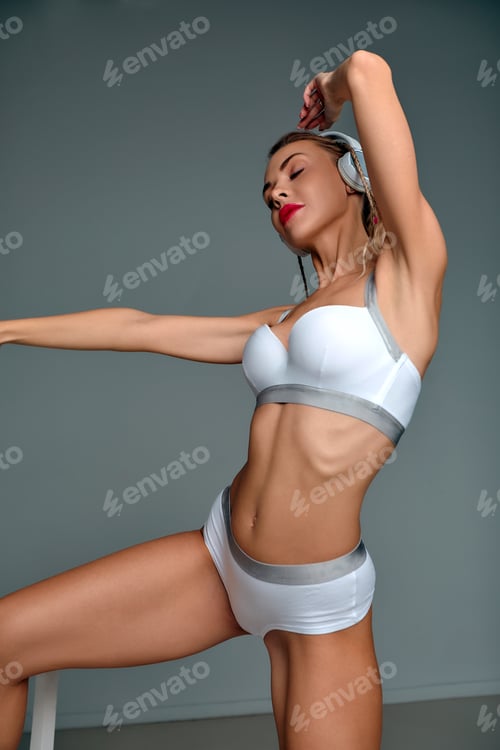 Preview: Banner of young happy girl in white swimsuit listening to music in white chair, wearing wireless