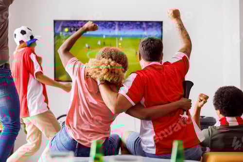 Preview: Friends cheering and celebrating while watching football on TV
