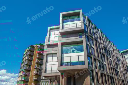 Preview: low angle view of beautiful modern houses against blue sky at Aker Brygge district, Oslo