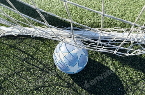 Preview: soccer ball flies into the gate on a green background. Close up.