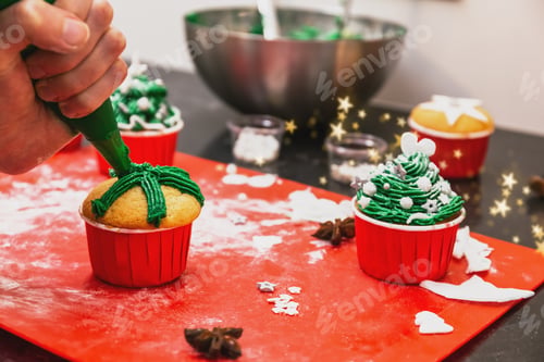 Preview: Baker making Christmas treat. Cupcakes shaped Christmas tree.