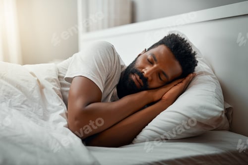 Preview: Sleeping in over the weekend. Cropped shot of a handsome young man sleeping in bed at home.