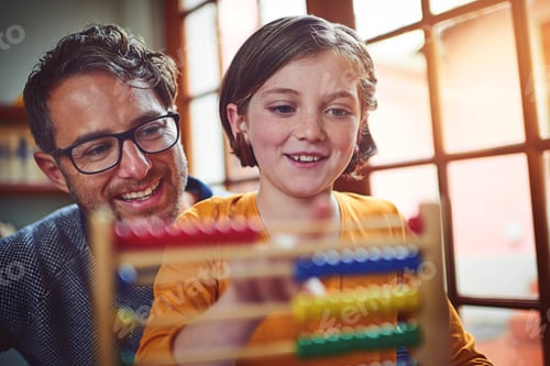 Preview: Nurturing bright young minds. Shot of a father helping his little daughter with her homework.