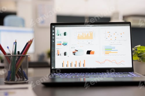 Preview: Portable computer with statistical infographics on a desk