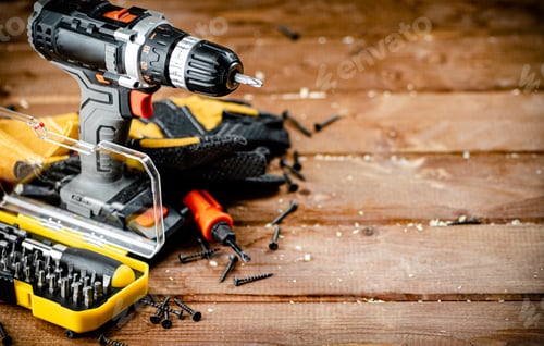 Preview: Cordless Drill and Tools on Wooden Work Surface