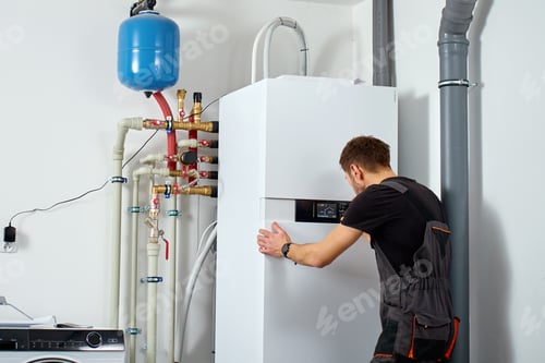 Preview: Technician installing heat pump system with pipes and expansion tank