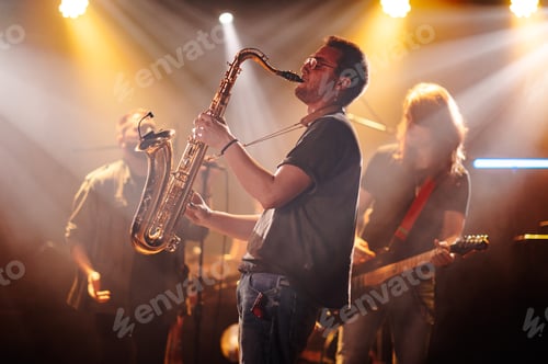 Preview: Saxophonist playing sax on stage with band during concert