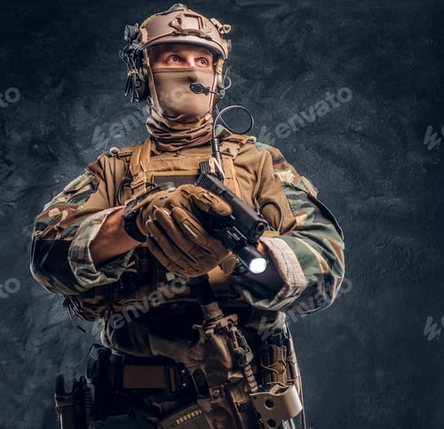Preview: Special forces soldier in camouflage uniform holding a gun with a flashlight