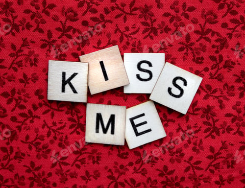 Preview: Kiss Me spelled out in wooden letter tiles for Valentine's Day
