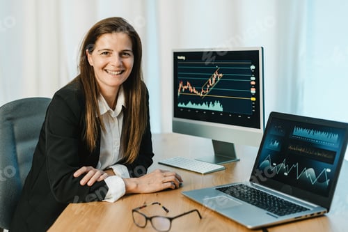 Preview: Cheerful woman trading on binary option in office