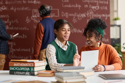 Preview: Two Cheerful Black Girls Laughing Enjoying Schoolwork in Class