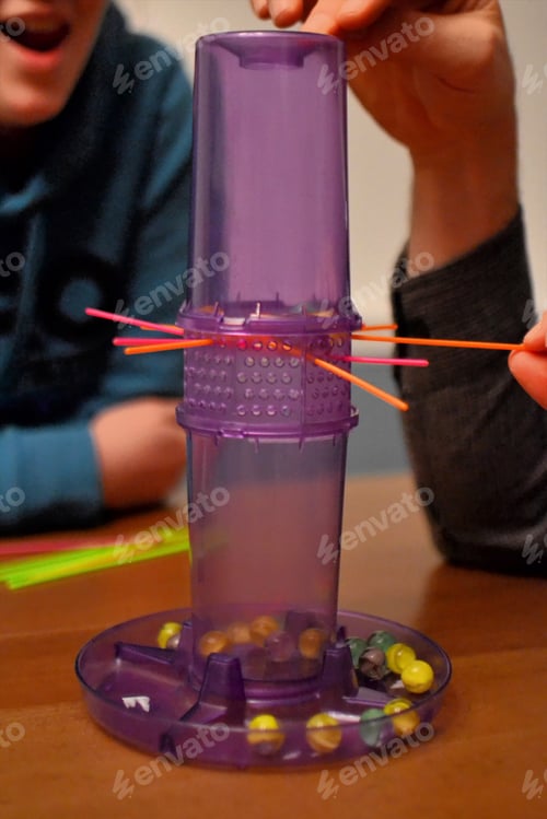 Preview: Family playing games during a snowstorm - Enjoying time together playing a classic game of Kerplunk