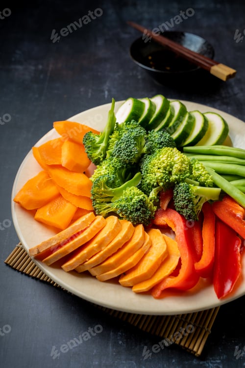 Preview: Side view of raw vegetable ingredients for Japanese tempura recipe on a plate, vertical