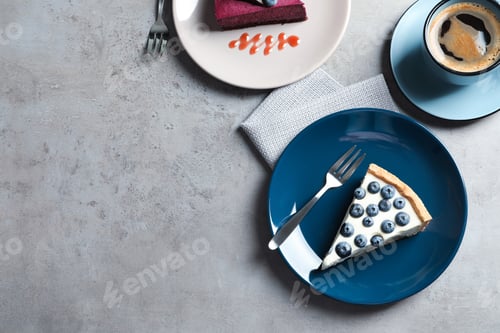 Preview: Flat lay composition with piece of tasty blueberry cake and space for text on gray table