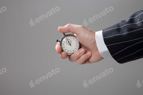 Preview: Man holding stop watch, close-up