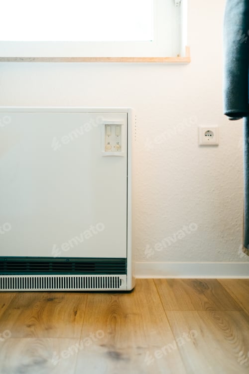 Preview: White electrical heating radiator for home. White heating battery in the room.