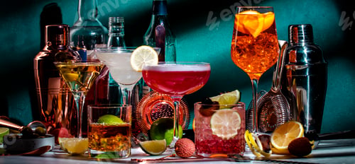 Preview: Cocktails. Strong drinks and aperitifs, bar tools, bottles on dark green background, hard light