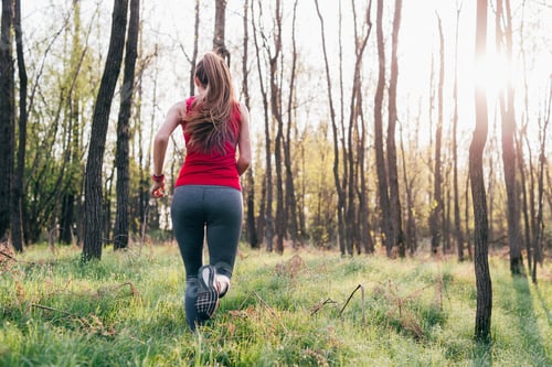 Preview: back view young woman running outdoor training in the nature