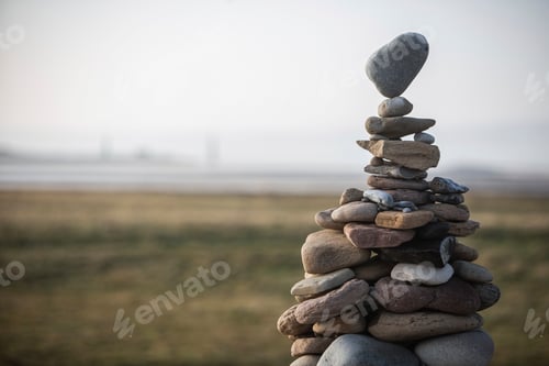 Preview: A serene stack of balanced stones against a softfocused natural backdrop.