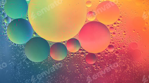 Preview: Abstract yellow, green, pink and blue colorful background with oil on water surface. Oil drops in