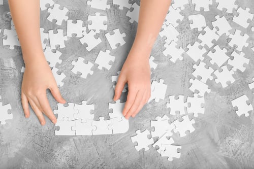 Preview: Baby hands assemble the puzzle on the table