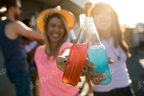 Preview: Group of happy friends having party on rooftop