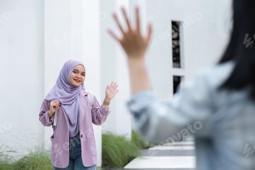 Preview: Young Muslim student greets fellow college students as they meet during free time