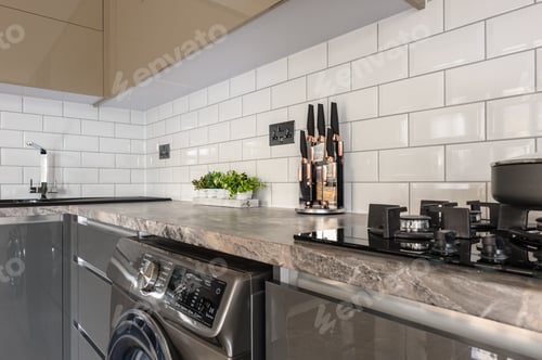 Preview: Closeup of luxury modern white, beige and grey kitchen interior