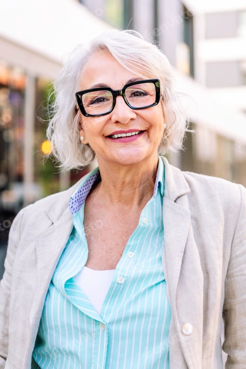 Preview: Smiling Senior Woman Wearing Glasses in City