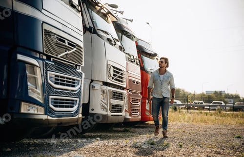 Preview: Many of the trucks are parked. driver is near the transport outdoors