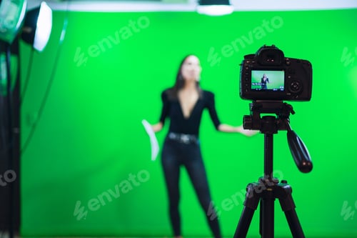 Preview: Woman reading text on paper while filming video