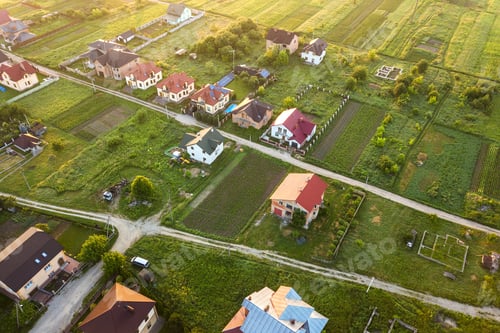Preview: Aerial landscape of small town or village with rows of residential homes and green trees.