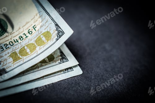 Preview: Close-up of 100 dollars banknotes on dark background